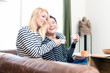 © Kzenon - Asian Couple on Sofa drinking coffee together