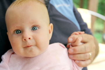 Newborn Baby Girl Holding Grandpa's Hand