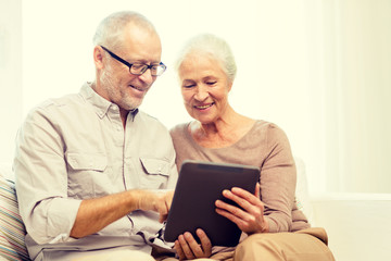 Wall Mural - happy senior couple with tablet pc at home