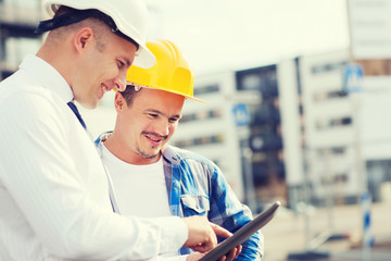 Sticker - smiling builders in hardhats with tablet pc