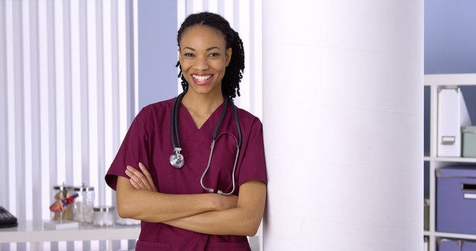 Wall Mural -  - Confident black woman doctor smiling in office