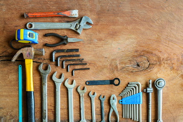 Set of work tools on old grunge wood background