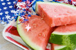 Holiday Watermelon – Slices of fresh watermelon, surrounded by patriotic red, white, and blue decorations.