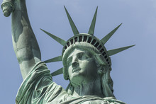 Closeup Of Statue Of Liberty With Blue Sky In Background