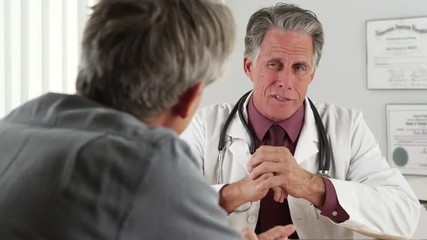 Wall Mural - Doctor consulting elderly patient in his office