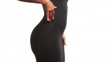 Mid Section Close Up Of Woman In Skin Tight Black Dress Dancing On White Background