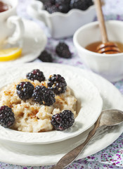 Wall Mural - Homemade Oatmeal with Blackberries, granola and honey for Breakf