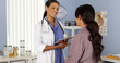 © rocketclips - African American gynecologist talking to patient with tablet