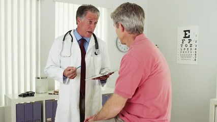 Wall Mural - Senior doctor talking with elderly patient