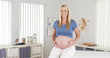 © rocketclips - Happy pregnant woman sitting in doctor's office