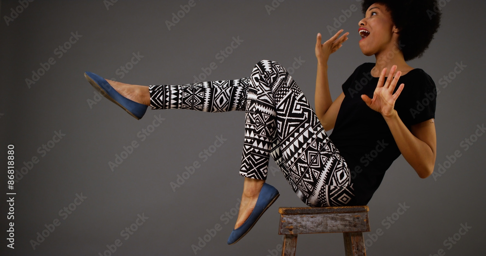 Black woman dancing on chair