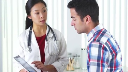 Wall Mural - Chinese doctor explaining neck xray to patient