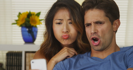 Wall Mural - Mixed Race couple taking selfies