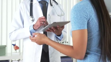 Wall Mural - Chinese patient talking to hispanic doctor