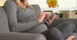 © rocketclips - Beautiful Pregnant woman surfing the web on tablet