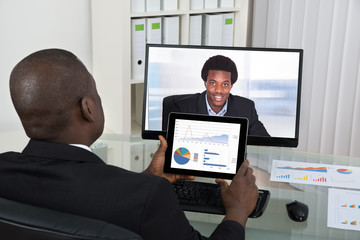 Businessman Video Chatting With Colleague On Computer