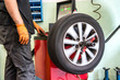 Mechanic balancing a car wheel