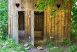 Old rural wooden toilet structure with three seats.