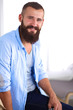 © lenets_tan - Young businessman sitting on chair in office