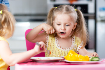 Little children eating food at daycare