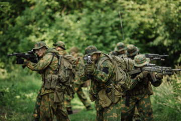 Group of soldiers special forces during the raid in the forest