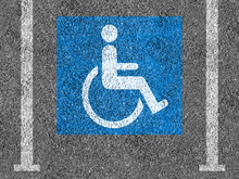 Blue And White Handicap Parking Symbol On Asphalt