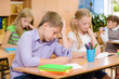 © Ermolaev Alexandr - Group of elementary school pupils takes the test in class