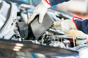 Poster - Auto mechanic changing motor oil