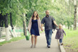 © kichigin19 - Mom and young daughter and dad, a young family on a walk in the park in summer