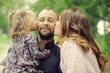 © kichigin19 - Mom and young daughter and dad, a young family on a walk in the park in summer