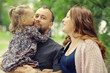 © kichigin19 - Mom and young daughter and dad, a young family on a walk in the park in summer