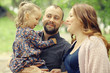 © kichigin19 - Mom and young daughter and dad, a young family on a walk in the park in summer