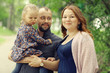 © kichigin19 - Mom and young daughter and dad, a young family on a walk in the park in summer