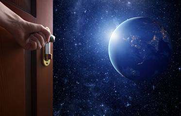 Wall Mural - room with open door.planet earth from the space. some elements of this image furnished by nasa