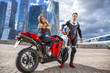 © Andrey_Arkusha - Young couple on a sports bike on the background of the city skyl