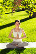 © yatcenko - Youngl woman doing yoga in the park in the morning