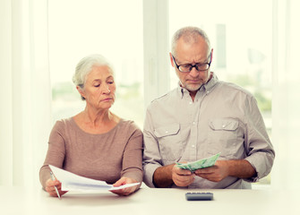 Poster - senior couple with money and calculator at home