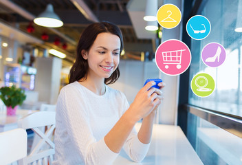 smiling woman with smartphone shopping online