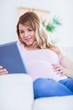 © WavebreakmediaMicro - Happy pregnant woman using tablet