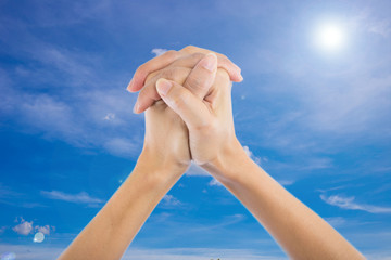 Praying Hands Isolated on sky background.