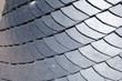 © brizmaker - Close up of slate roof tiles background