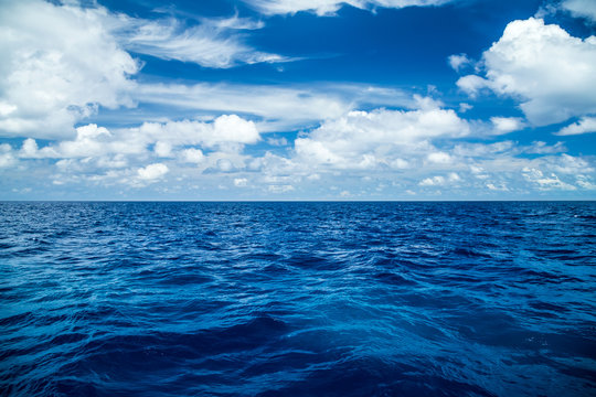 blue ocean background with blue cloudy sky