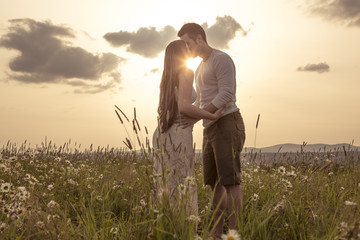 Young couple in love outdoor at the sunset