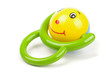 Baby toy with smile and green handle isolated on the white background