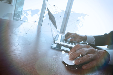 business man hand working on laptop computer on wooden desk