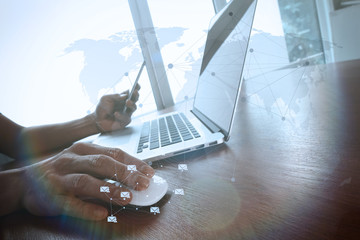 business man hand working on laptop computer on wooden desk