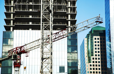 Construction site with cranes on building background