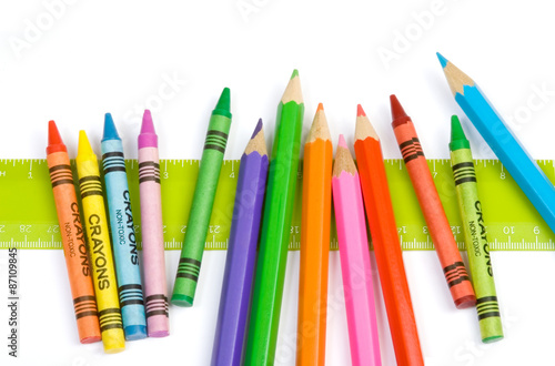 Fotografie, Obraz Ruler and Crayon Border – A green ruler, with crayons and colored pencils