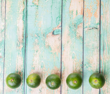 Calamansi Citrus Over Weathered Wooden Background