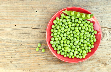 Green peas on the red plate